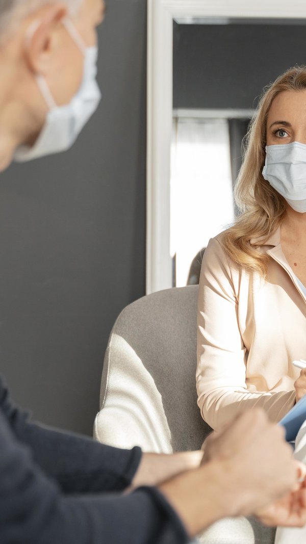 man_with_mask_talking_to_woman_counselor