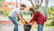 men_and_women_help_each_other_to_collect_garbage