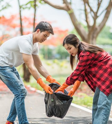 men_and_women_help_each_other_to_collect_garbage